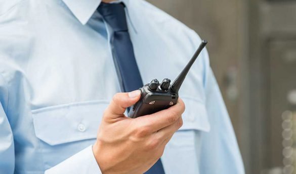security-guard-using-a-walkie-talkie security-guard-using-a-walkie-talkie